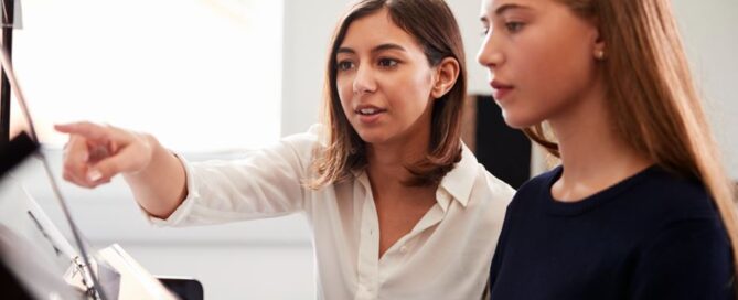 Female Music Teacher Teaching Teen Student Lesson