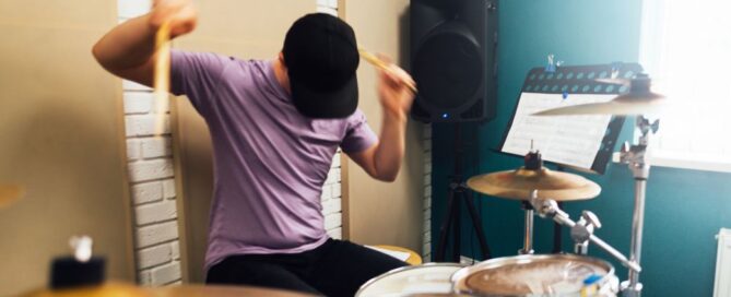 Teen playing drums expressively
