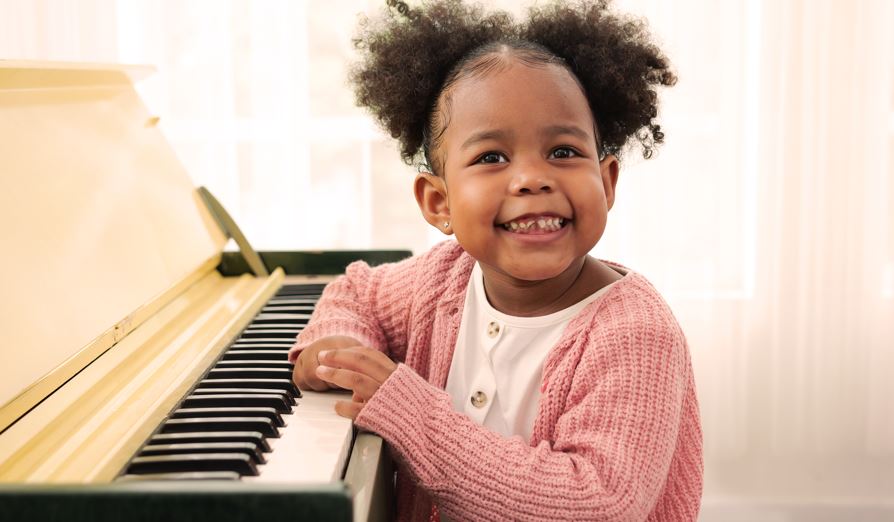 Child happy playing musical instrument