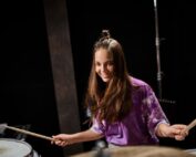 Teen girl learning drums