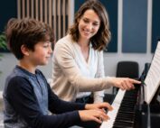 Music Teacher giving piano lesson to young boy